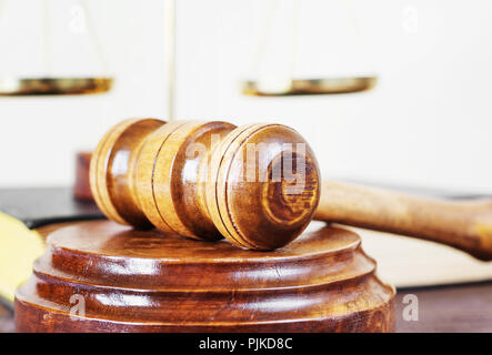 Symbole des Gesetzes: Holz Hammer, soundblock, Waagen und volumetrische Buch auf einem Holztisch Stockfoto
