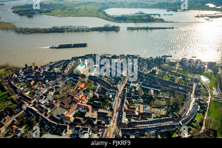 Blick auf den Rhein bei Rees mit Kirche St. Maria Himmelfahrt katholische Pfarrkirche im Zentrum von Rees, Binnenschifffahrt mit Frachtschiffen, Rees, Niederrhein, Nordrhein-Westfalen, Deutschland Stockfoto