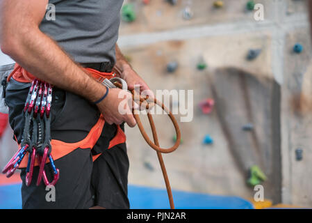Rock Wall climber tragen und Kletterausrüstung Indoor, Nahaufnahme Stockfoto