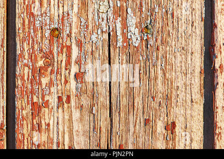 Alte Holz- Hintergrund der vertikalen Bretter mit Peeling rote Farbe Stockfoto