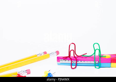 Zwei Büroklammern reden, sitzen auf einem Zick-zack-Scheren mit Bleistifte in den Hintergrund. Miniatur Schule leben und zurück in die Schule Konzept mit Kopie Raum Stockfoto