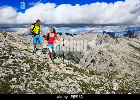 Wanderer auf der Aufstieg von der Plätzwiese auf den Gipfel des Dürrenstein, im Hintergrund die Gipfel der Drei Zinnen von Stockfoto