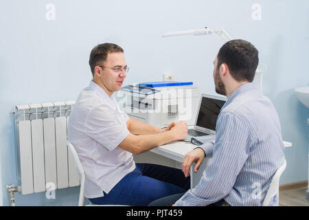 Besorgt Patient mit seinem Arzt in der Arztpraxis Stockfoto