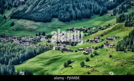 Kleines Dorf von Colfosco auf den Hügeln mit grünen Wiese im Sommer, Alta Badia - Trentino-Südtirol, Italien