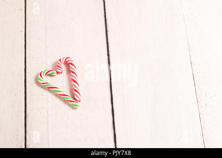 Herzförmige Zuckerstangen auf weißen Holzmöbeln rustikal Schreibtisch. Stockfoto