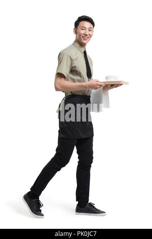 Junger Kellner mit einer Tasse Kaffee Stockfoto