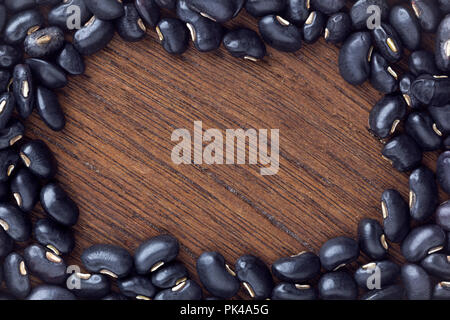 Schwarze Bohne auf Holztisch. top View Stockfoto