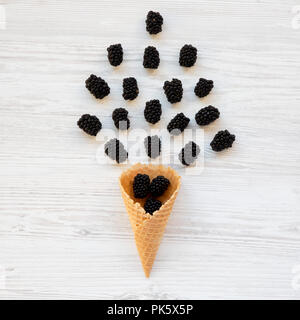 Ansicht von oben Waffel süßen Eis mit Brombeeren auf einem weißen Holztisch. Flach, Overhead, von oben. Stockfoto