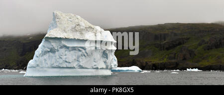 Eisberg schwimmend im Wasser vor der Küste von Grönland. Natur und Landschaft Grönlands. Stockfoto