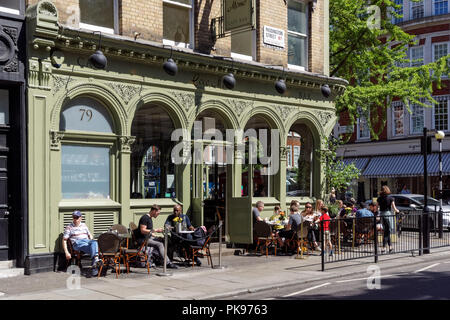Menschen außerhalb Coco Momo Restaurant in Marylebone, London England United Kingdom UK sitzen Stockfoto