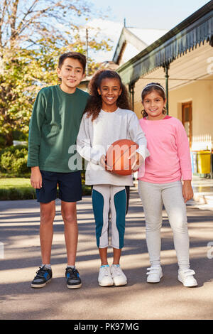 Drei multikulturellen Grundschüler als Team im Basketball Stockfoto