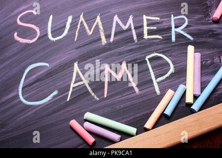 Worte Summer Camp mit bunter Kreide auf Tafel geschrieben. Top Aussicht, Flachbild. Ferienhäuser Konzept. Freizeit Stockfoto