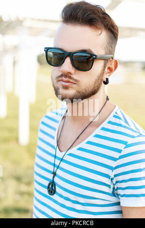 Sonnige Portrait von ein stattlicher Mann mit Bart am Strand. Stockfoto