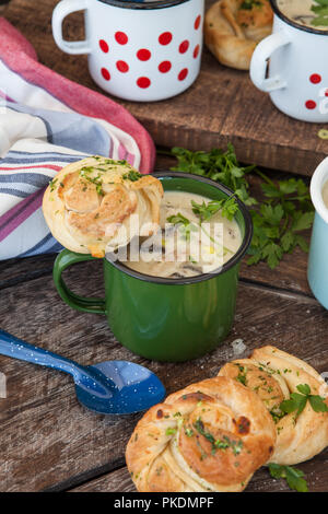 Cremige Pilzsuppe mit frischen Parley im rustikalen Emaille Becher Stockfoto