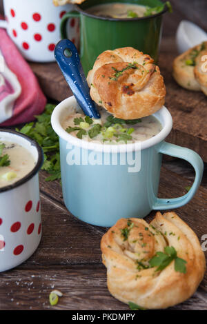 Cremige Pilzsuppe mit frischen Parley im rustikalen Emaille Becher Stockfoto