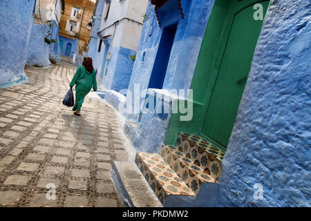 Eine traditionelle marokkanische Frau gekleidet, Spaziergänge in der Altstadt (Medina) von Marrakesch in Marokko. Stockfoto