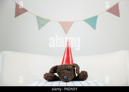 Kinder party Konzept mit flauschigen Spielzeug Hund am Tisch. Stockfoto