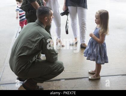 Us Marine Lt Colonel Steven M. Schrieber spricht mit einem jungen Mädchen warten auf ihren Vater nach Hause von einem sieben Monate Bereitstellung mit dem 26 Marine Expeditionary Unit (MEU) bei Marine Corps Air Station Cherry Point, N.C., am 2. August 2018 zurück. Marines wurden von Familien, Freunden und Lieben im Marine Attack Squadron 542 Hangar. Die Marines sind mit VMA-542, Marine Flugzeuge Gruppe 14, 2. Marine Flugzeugflügel. Stockfoto