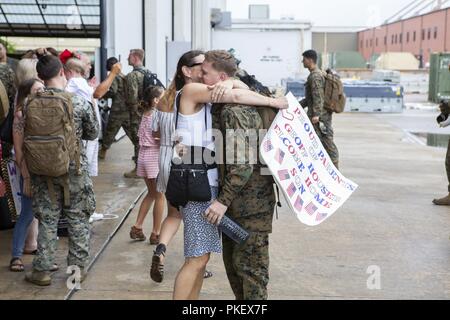 Us Marine Cpl. Geoff Houser Umarmungen seiner Mutter nach der Rückkehr nach Hause von sieben - Monat Bereitstellung mit 26 Marine Expeditionary Unit (MEU) bei Marine Corps Air Station Cherry Point, N.C., am 2. August 2018. Marines wurden von Familien, Freunden und Lieben im Marine Attack Squadron 542 Hangar. Die Marines sind mit VMA-542, Marine Flugzeuge Gruppe 14, 2. Marine Flugzeugflügel. Stockfoto