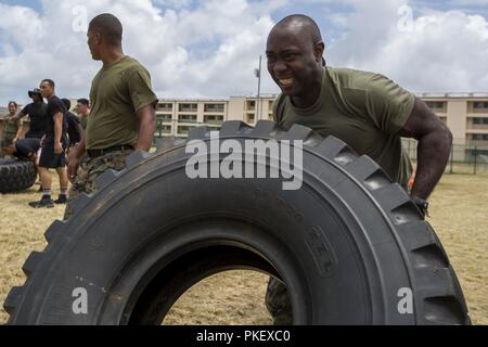 Us Marine Corps Master Sgt. Carl Nelson, die menschliche Arbeitskraft Informationssysteme Personal noncommissioned Officer Leiter mit Sitz Bataillon (HQBN), Marine Corps Base Hawaii (MCBH), konkurriert in einem Reifen flip Konkurrenz während der HQBN Feld treffen, MCBH, Aug 2, 2018. Das Bataillon bewirtete das Feld treffen Ausfallsicherheit zu fördern, Moral und Zusammenhalt stärken. Stockfoto