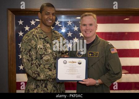 NEWPORT NEWS, Virginia (Aug. 3, 2018) Leutnant Terrence Smith, von Virginia Beach, Virginia, auf USS Gerald R. Ford's (CVN 78) Versorgung der Abteilung zugewiesen, erhält seine Oberfläche Kriegsführung Supply Corps Officer Zertifikat von Kapitän Richard McCormack, Ford's kommandierender Offizier. Stockfoto