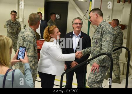 Sen. Heidi Heitkamp, North Dakota, schüttelt Hände mit Kol. Britt Hatley, die 119 Wing Commander, reg. Doug Burgum sieht nach einem Befehl Zeremonie Einführung Oberst Darrin Anderson als der neue 119 Wing Commander am North Dakota Air National Guard Base, Fargo, N.D., Aug 4, 2018. Oberst Darrin Anderson ist Austausch Hatley, wer hat die 119 Wing Commander seit Februar 4, 2017. Stockfoto