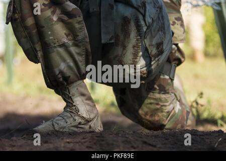 Ein U.S. Army Reserve Soldat aus der 302Nd Militärpolizei Unternehmen erhält nach Kriechen unter einem stacheldraht Hindernis bei Lethal Warrior Training am Fort McCoy, Wisconsin, am Aug 8, 2018. Stockfoto