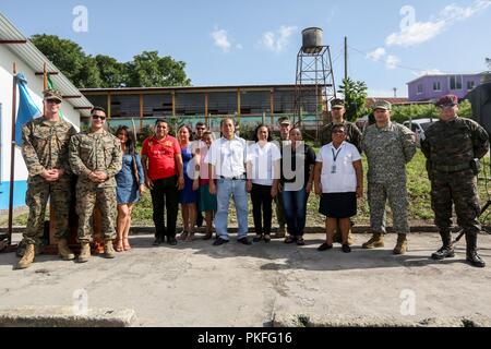 Us-Marines mit Zweck Marine Air-Ground Task Force - Southern Command und guatemaltekischen militärischen und zivilen Führer stehen an Aufmerksamkeit während dem Spielen der USA und Guatemala nationalhymnen vor dem Ribbon Cutting und Transfer von Tasten auf einer Baustelle, wo Marines zusammen mit Guatemaltekischen Ingenieure in La Paz, Guatemala, Aug 6, 2018 arbeitete. Die Marinesoldaten und Matrosen von SPMAGTF - SC sind die Zusammenarbeit im Bereich Sicherheit Training und Engineering Projekte Neben partner Nation militärischen Kräfte in Zentral- und Südamerika. Das Gerät ist auch auf Standby zu humanitären unterstützen Stockfoto