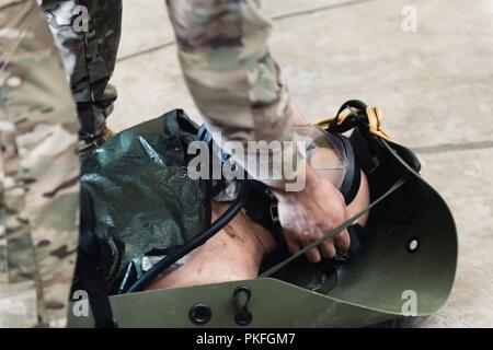 Staff Sgt. Michael Galindo, 320 Spezielle Taktiken Squadron pararescueman, überprüft die Dichtung eines Tauchen Maske zu einer trainingspuppe während einer Rettung Taktiken Demonstration angeschlossen, 10.08.2018, bei Kadena Air Base, Japan. Dutzende von US-Militärpersonal, einschließlich Pararescue Flieger in Okinawa, waren Teil einer multinationalen Bemühung, dass 12 junge Fußballer und ihrer Trainer aus einer Hoehle in Thailand gesichert. Stockfoto