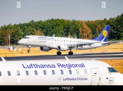 Eine Embraer 190 (D-AECI) der Lufthansa CityLine Landung auf dem Der nordwestbahn am Frankfurter Flughafen. Im Vordergrund ein Bombardier CRJ-900 (D-ACNP) Stockfoto