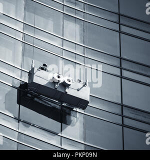 Bürogebäude Wartung, Glasfassade Reinigung mit Ladestation. Quadrat blau getönten Foto Stockfoto