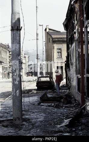 15. März 1993 während der Belagerung von Sarajevo: Ein junger Mann steht in den Trümmern des Krieges forlorn zerrissenen Stadt Hiseta Straße. Stockfoto