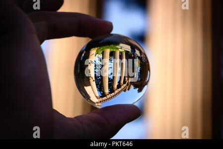 Finger, die eine Glaskugel, die die Säulen der Palast der Schönen Künste Theater in San Francisco. Stockfoto