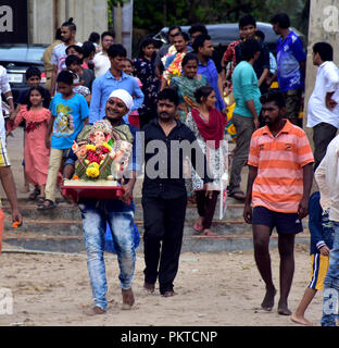 Mumbai, Indien. 14 Sep, 2018. Ein indisch-hinduistischen Devotee trägt ein Idol der elefantenköpfige Ganesha Hindu Gott für Eintauchen in Arabischen Meer am Juhu Beach auf der Ona und halber Tag der 10-tägige Festival Ganesh Chaturthi in Mumbai. Hindu devotees zu Hause Idole von Lord Ganesha, um seinen Segen für Weisheit und Wohlstand zu berufen. Credit: Azhar Khan/ZUMA Draht/Alamy leben Nachrichten Stockfoto