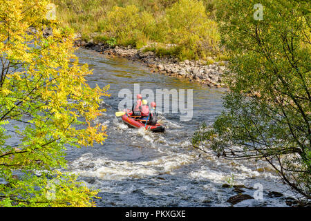 RIVER SPEY SCHOTTLAND HERBSTLICHE BÄUME UND Kanu oder Floß MIT DREI PERSONEN RAFTING EINE AUSDEHNUNG DES WEISSEN WASSER Stockfoto