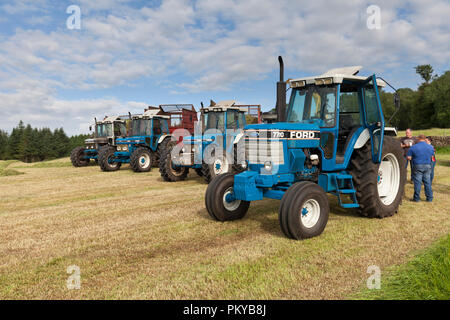 Line-up von Vintage Serie 10 Ford Traktoren zu sammeln Silage auf einer Molkerei in England verwendet wird von links nach rechts 7810 Silver Jubilee, 7810, 6810, 7710 Stockfoto