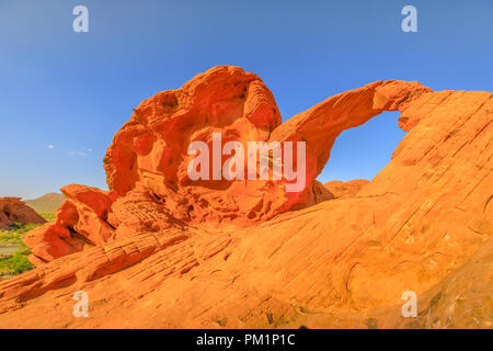 Die ikonischen Arch Rock ein natürlicher Bogen entlang der Tal des Feuers Scenic Loop, Nevada's älteste State Park berühmt für rote Sandsteinformationen von den großen Wanderdünen im Zeitalter der Dinosaurier gebildet. Stockfoto