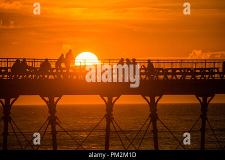 Aberystwyth Wales UK, Montag, 17. September 2018 UK Wetter: Menschen auf der Pier in Aberystwyth genießen Sie einen Drink in der bemerkenswert warmem Wetter, wie sie für Storm Helene warten in der Nacht zu rollen. Im Westen von Großbritannien stützen sich auf die Auswirkungen der Sturm Helene, die prognostiziert wird heute Abend und morgen Vormittag, mit Winde, die bis zu 70 mph in exponierten Gebieten und die Gefahr der Lebensgefahr durch Umherfliegende Trümmer Foto © Keith Morris/Alamy leben Nachrichten Stockfoto