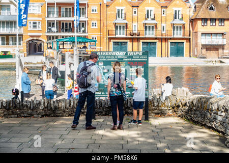 Eine Familie zu stoppen und ein Zeichen über den Fluss Bootsfahrten entlang der Themse in Windsor lesen. Stockfoto