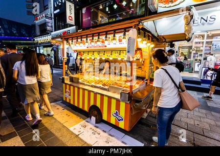 Suwon, Südkorea - 14. Juni 2017: Anbieter Frau warten auf Käufer in ihrer fast food Kiosk an der Hauptstraße in Suwon. Street Food ist sehr beliebt in Kore Stockfoto