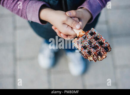 Waffeln mit Schokolade in den Händen. Belgische Waffeln Stockfoto