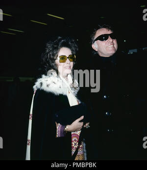Elizabeth Taylor im Bild mit ihrem Ehemann Schauspieler Richard Burton verlassen den Flughafen Heathrow für die Schweiz, 1971. Datei Referenz # 32603 396 THA Stockfoto