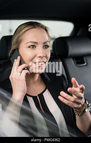 Im Auto telefonieren Handy Geschäftsfrau Stockfoto