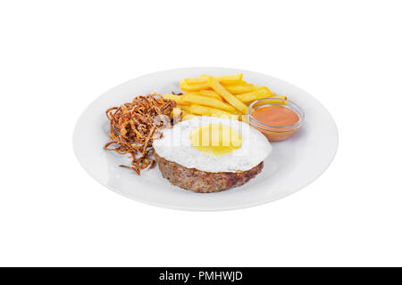 Schnitzel, Rindfleisch Steak, Lamm mit Rührei, Pommes frites, gebratenen Zwiebeln und orange Sauce auf einer Platte, isolierten weißen Hintergrund. Von der Seite. Für Stockfoto