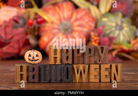 Happy Halloween Text mit Holzblock Buchstaben auf einem bunten Herbst Hintergrund geschrieben Stockfoto