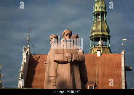 Lettischer Riflemen, Blick auf das Lettland Riflemen Monument und das Dach des Hauses der Blackheads und der Turmspitze der St. Peter's Church, Riga, Lettland. Stockfoto