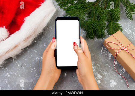 Weibliche Käufer macht, um auf den Bildschirm des Smartphones mit kopieren. Weihnachten online einkaufen. Frau kauft Geschenke für Weihnachten. Winterurlaub Vertrieb. Stockfoto