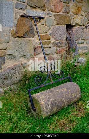 Stein Gras Walze außerhalb eines Cottage aus dem 17. Jahrhundert - Stag Ende lange Haus Ryedale Folk Museum, Hutton le Hole, Yorkshire, Großbritannien Stockfoto