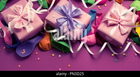 Banner festlichen Hintergrund violett Material bunte Luftballons luftschlangen Konfetti drei Boxen Geschenk. Ansicht von oben flach kopieren Raum toning Stockfoto