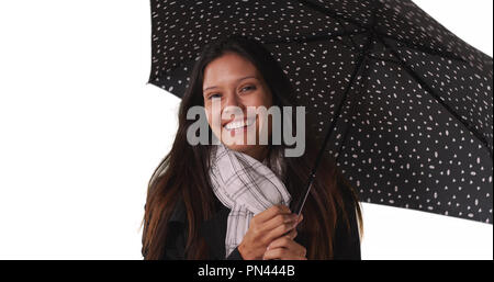 Schöne Frau mit gepunkteten Regenschirm lächelnd auf weißem Hintergrund Stockfoto